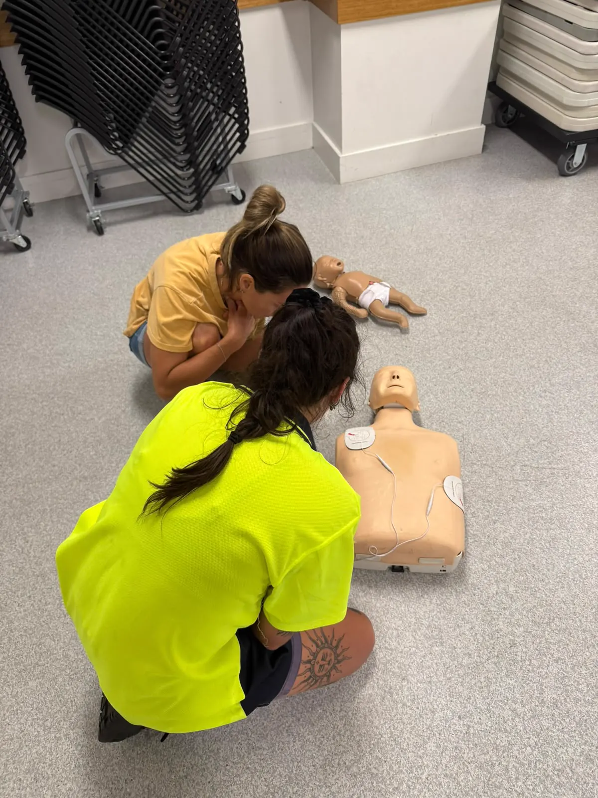 AED pad placement and CPR practice during first aid training