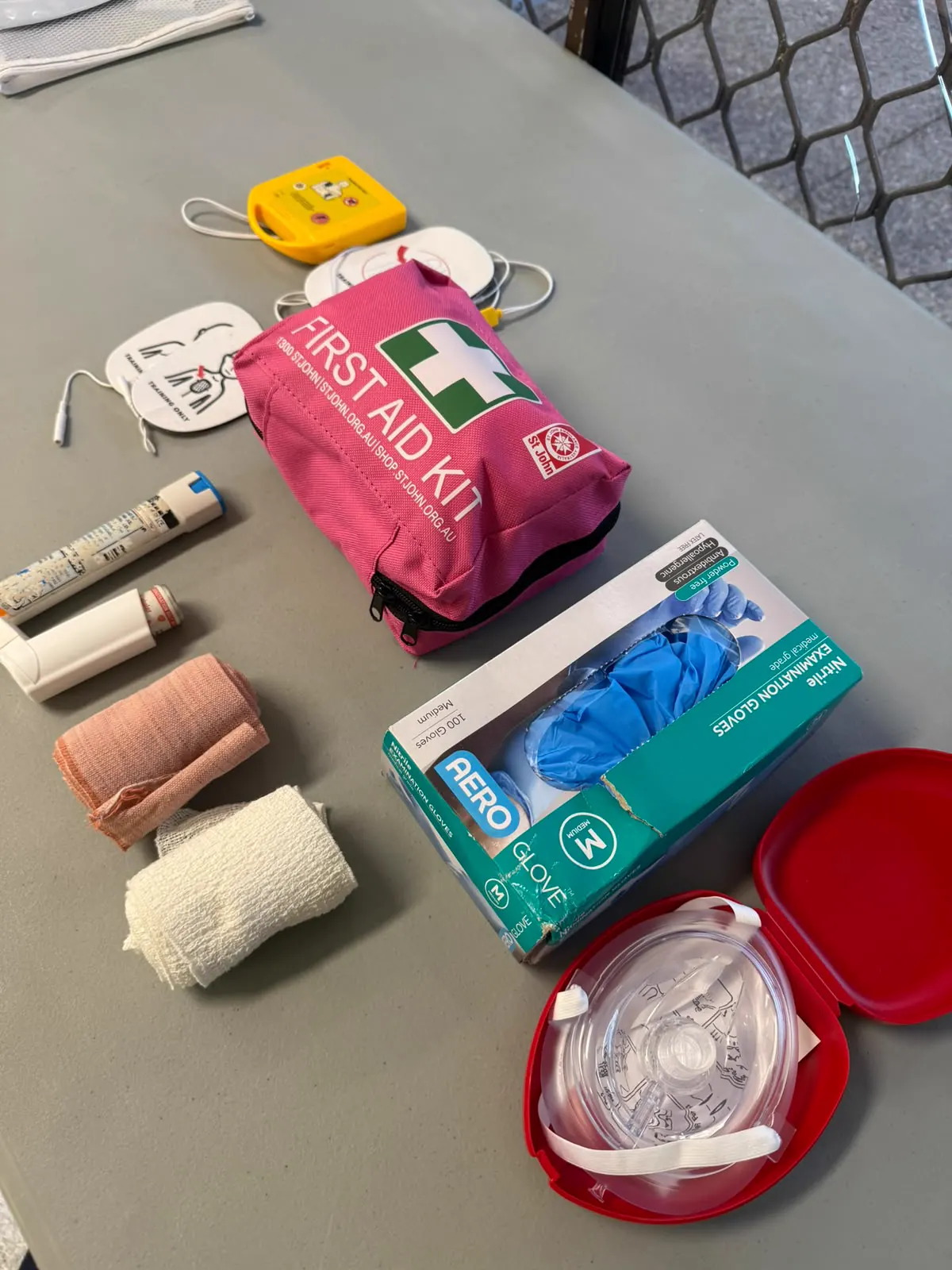 First aid kit, AED pads, asthma inhalers, bandages and gloves used in training