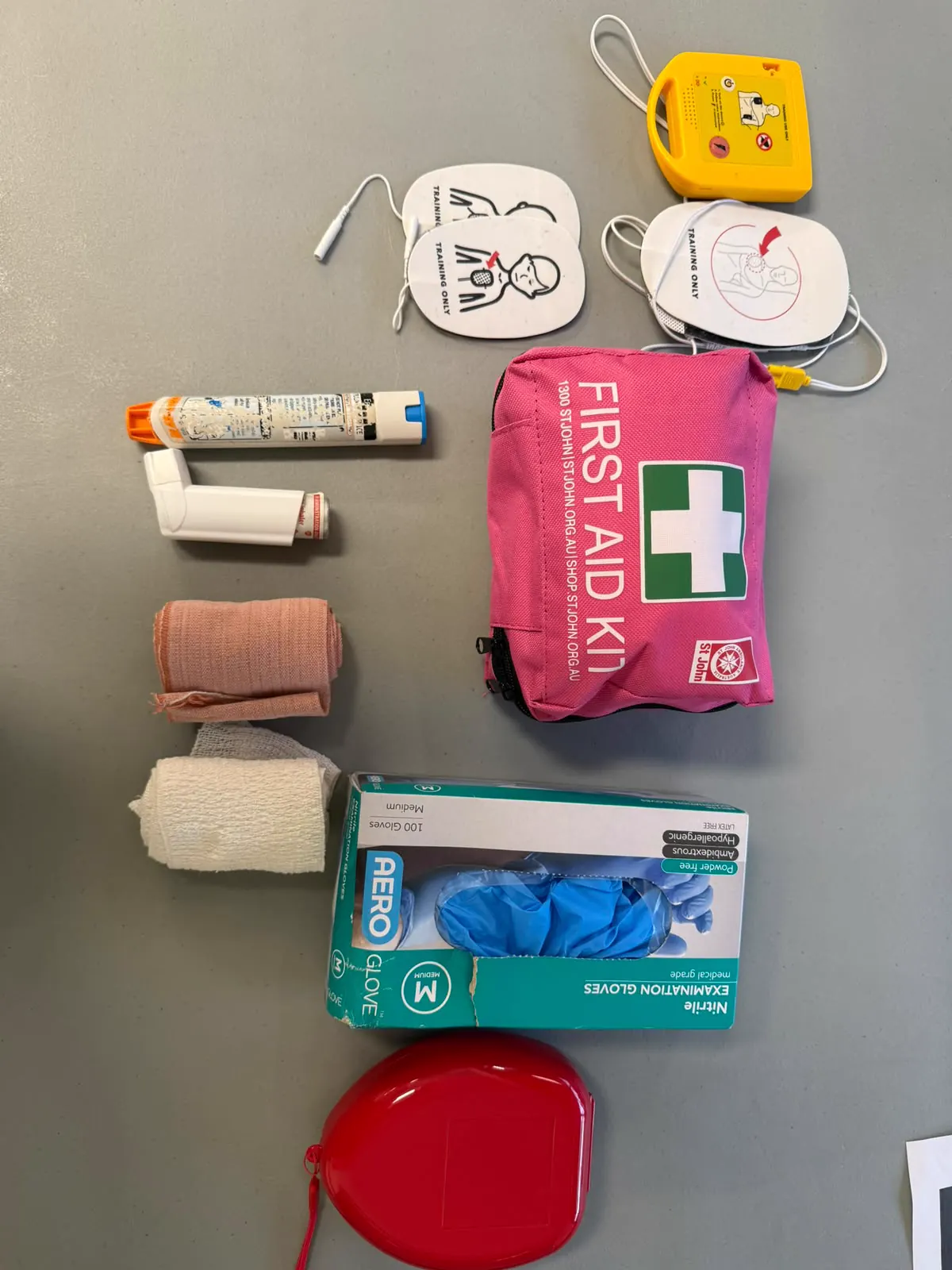 Workplace first aid equipment including AED pads, bandages, gloves and first aid kit